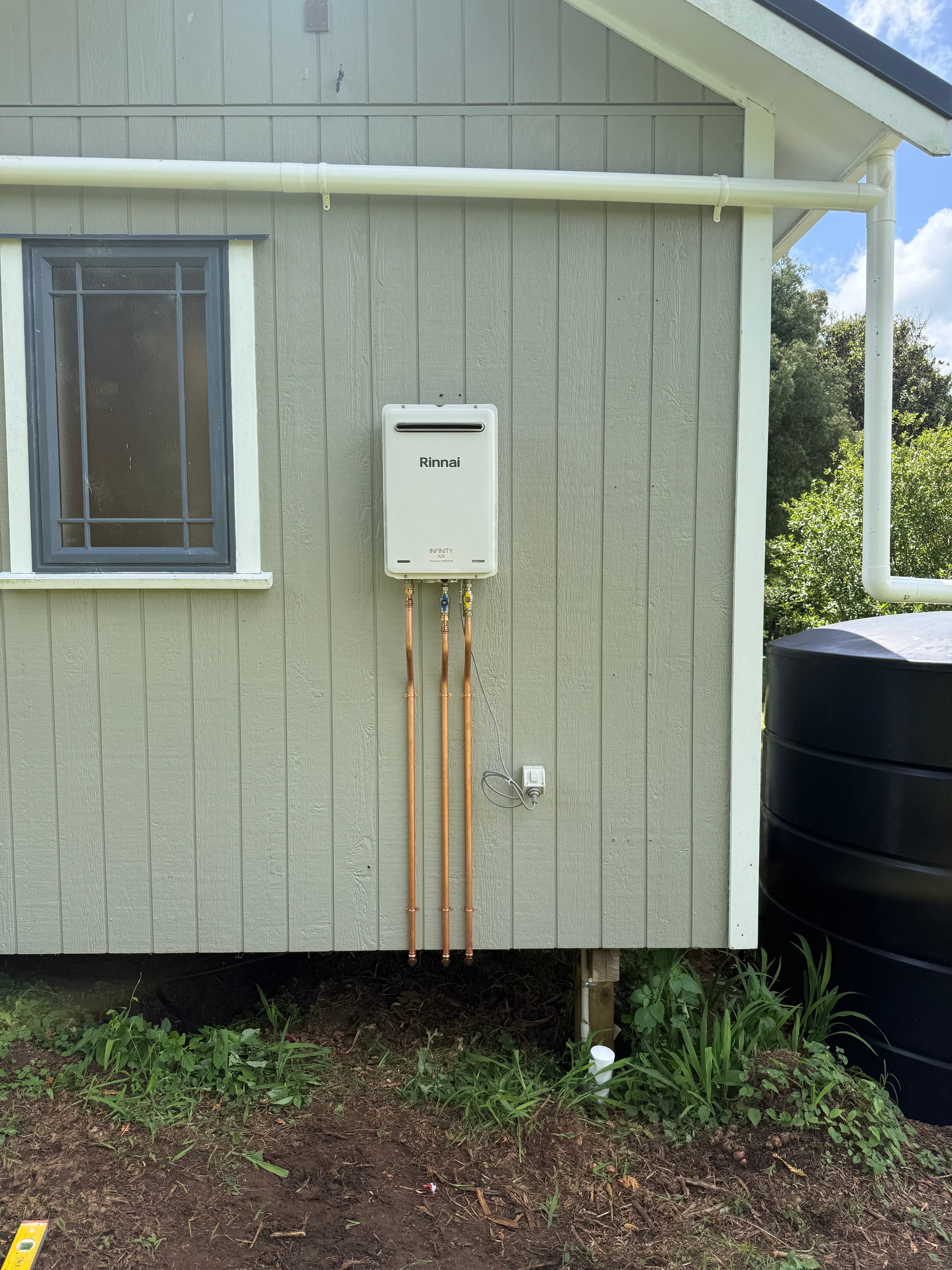 Rinnai continuous flow hot water unit installed on exterior wall
